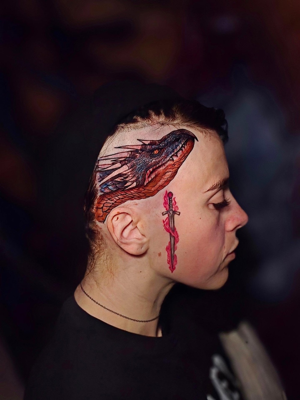 Dragon tattooed on the side of a head
