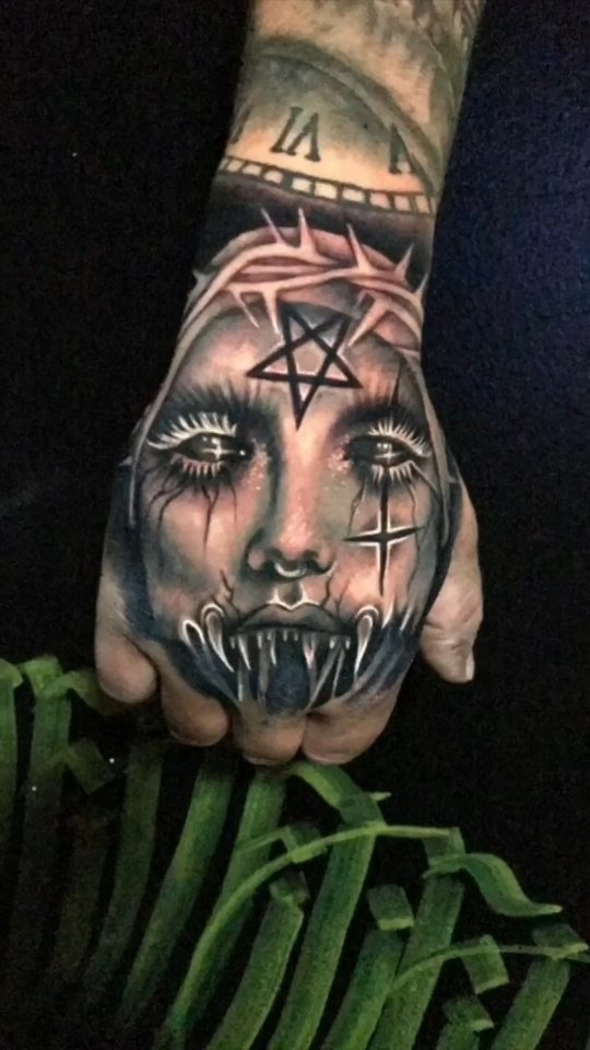 Horror face on the back of a hand
